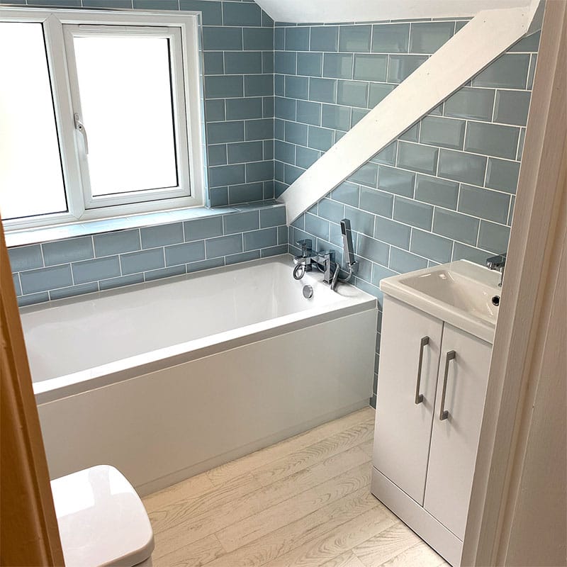 Compact loft bathroom with metro tiling